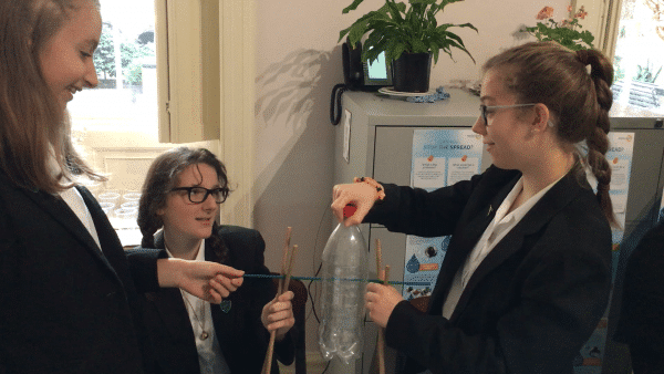 A Practical Action group of girls are working on a science project.