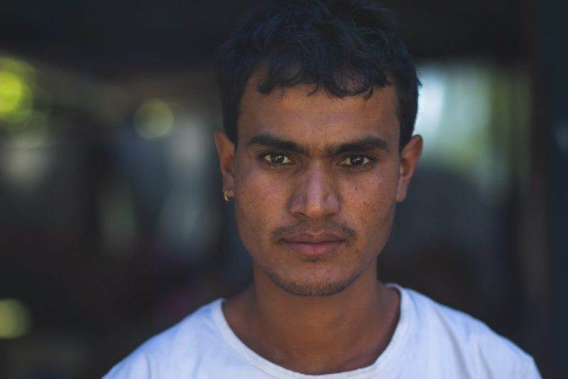 A determined dreamer in a white shirt is staring at the camera.