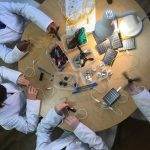 A group of students participating in The Solar Challenge, working on a project in a lab.