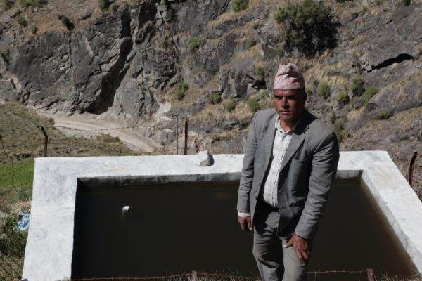 A BICAS man standing next to a pool in Karnali.