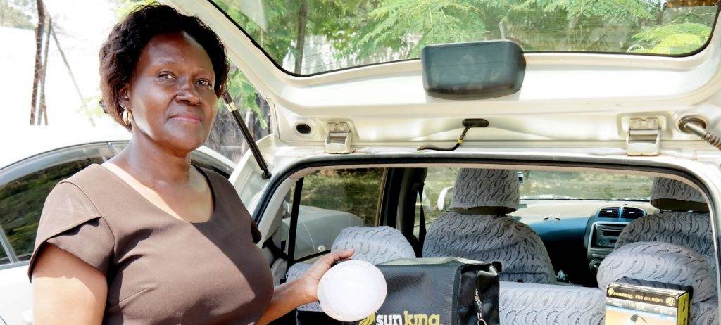 The Global Distributors Collective launches a woman standing in the back seat of a car.