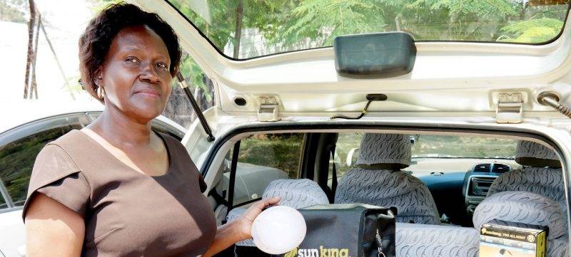 The Global Distributors Collective launches a woman standing in the back seat of a car.