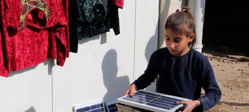 Refugee girl using renewable energy