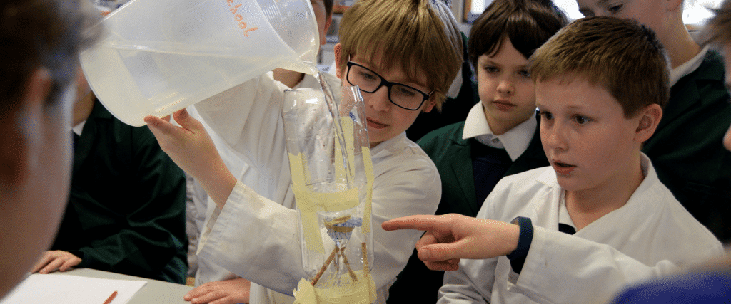 A group of boys are working on a science experiment to stop the spread of something.