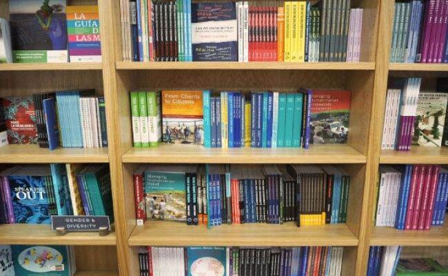 A publishing collection of books on a bookshelf.