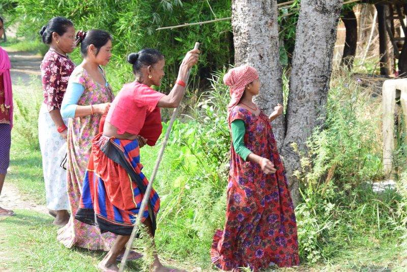 A group of women practicing next to a tree in Nepal.
