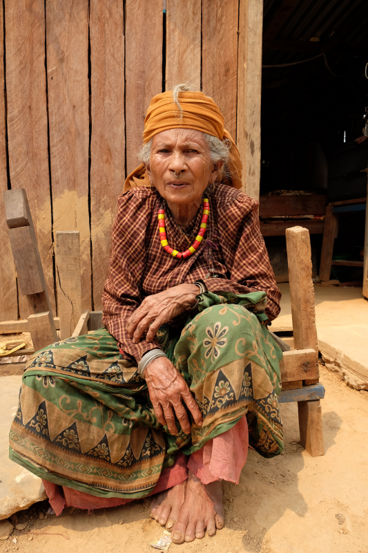 An old woman partakes in a rebuilding project applauded by the UK Government in Nepal.