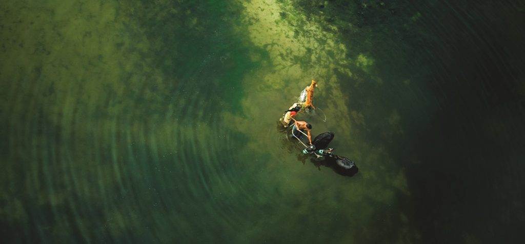 An aerial view of a person floating in the water, fulfilling a wish for tranquility.
