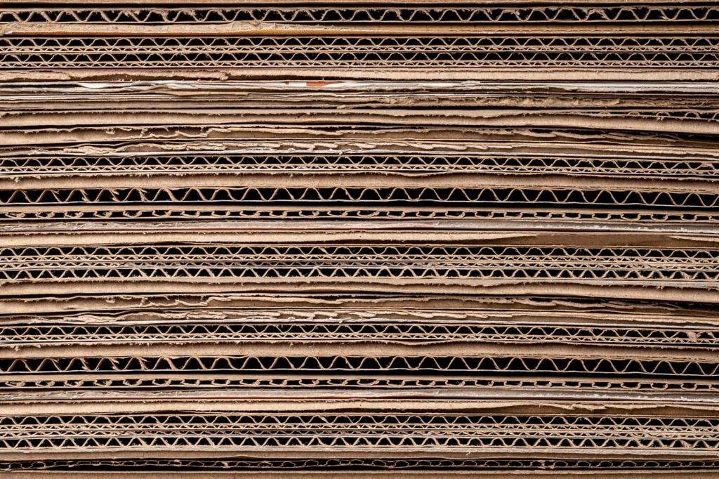 A stack of cardboard boxes on a black background, showcasing a sleek design.