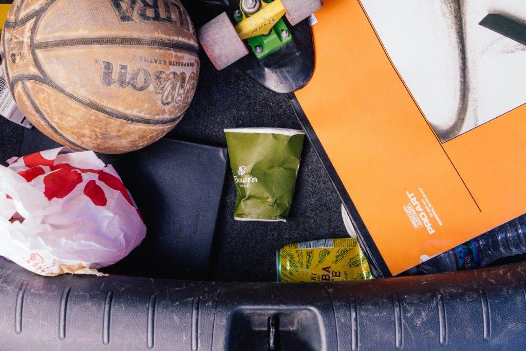 A basketball stored in the trunk of a car, promoting resourcefulness and reusability.