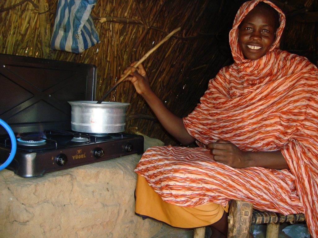 A woman cooking in front of a stove receives a life-changing donation.