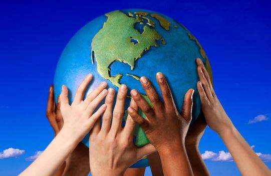 Young people holding a globe