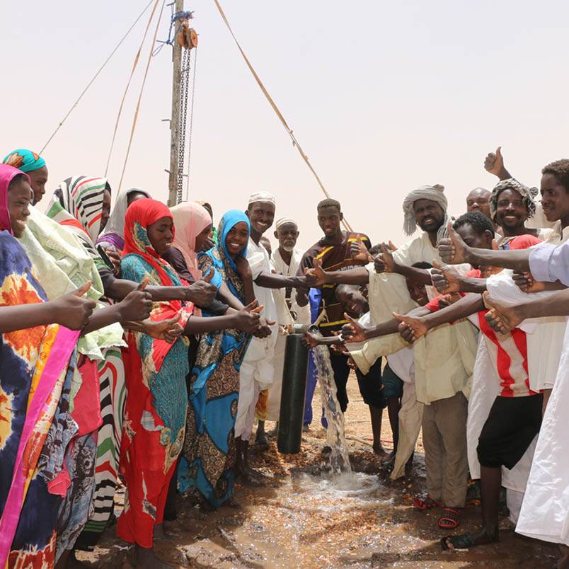 A group of Changemakers standing around a pole.