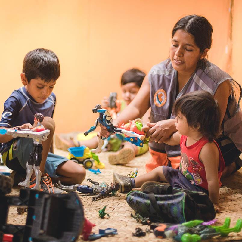 A group of children playing with e-gift toys in a room.
