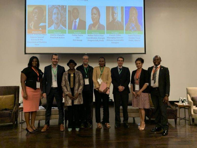 A group of people attending the 2019 ECOWAS Sustainable Energy Forum standing in front of a projection screen.