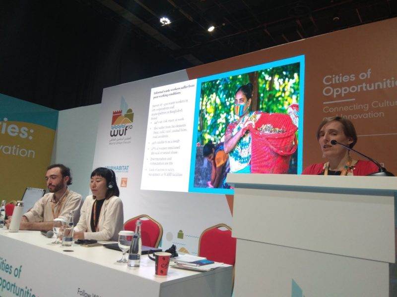 Keywords: waste services, World Urban Forum 2020. 

Modified Description: Group discussing waste services at the World Urban Forum 2020.