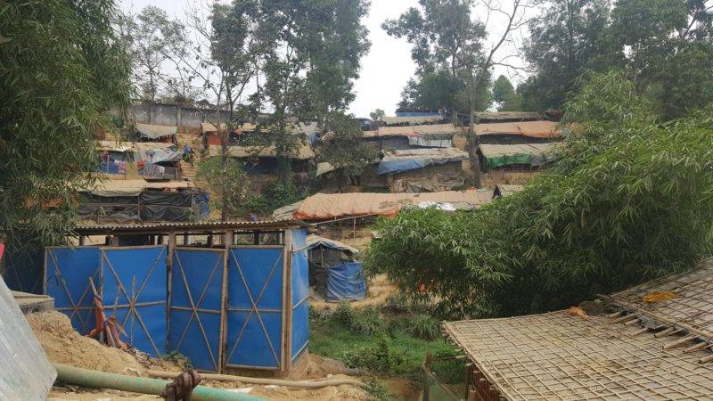 A group of slum shacks in a hilly area, inspiring change.