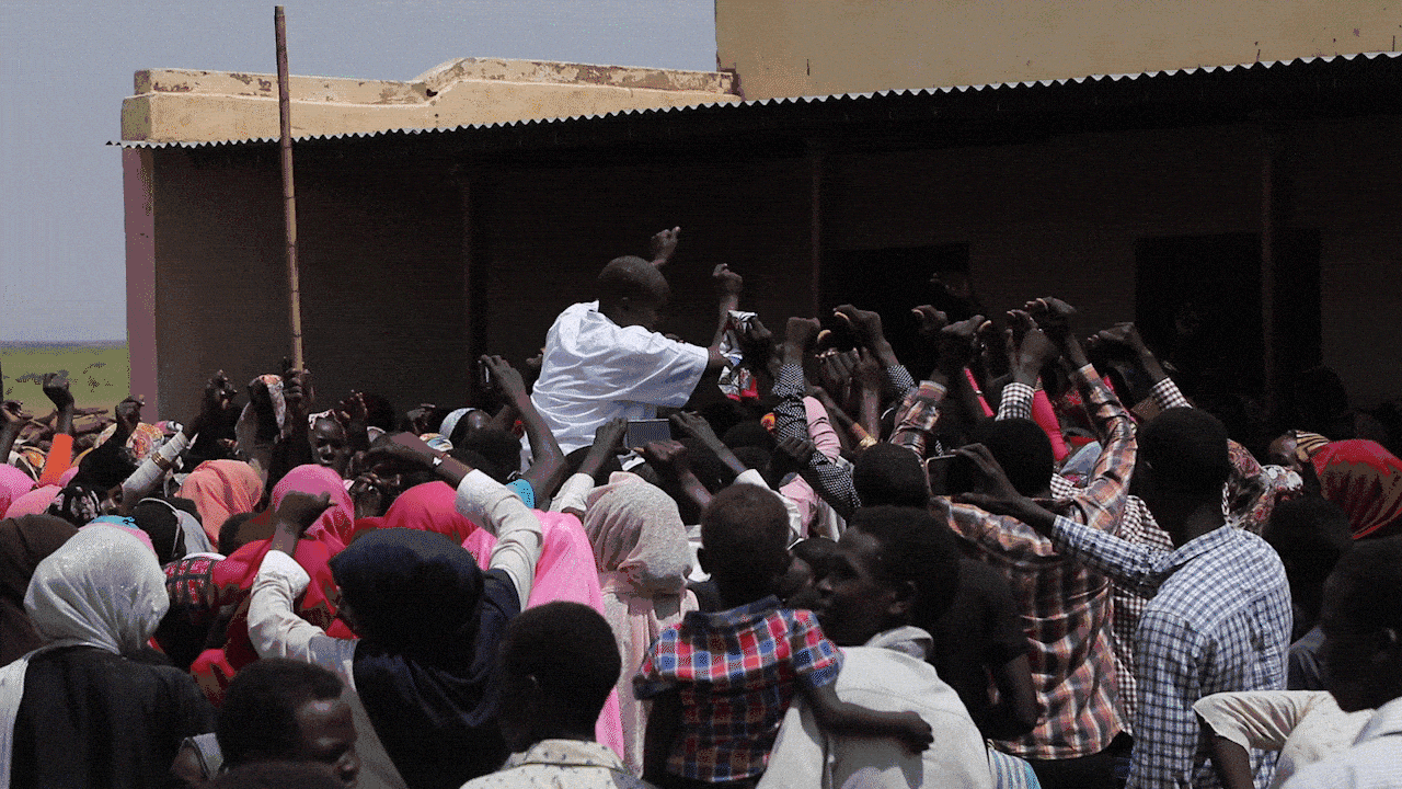 PART 1 - A crowd of people standing in front of a building at Darfur's new disco destination.