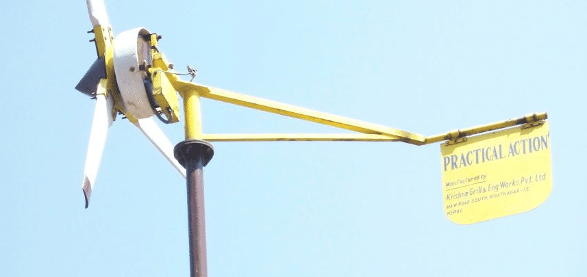 A sign-adorned wind turbine captures the essence of renewable energy.