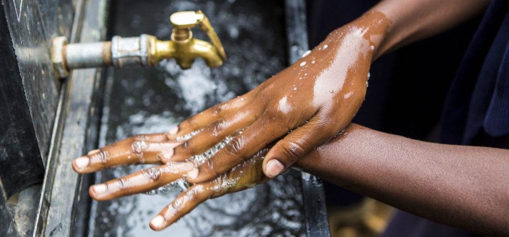 Child washing hands at Salam School
