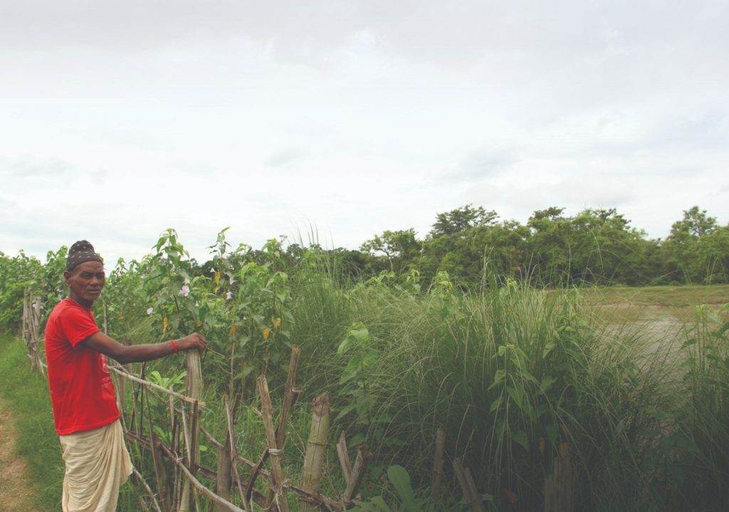 A woman with a special feature standing next to a fence.