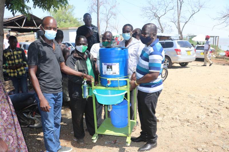 A group of people prioritizing hand hygiene by wearing face masks.