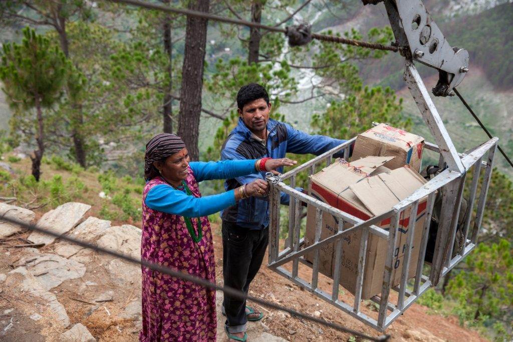 A vegetable cable car being loaded with goods