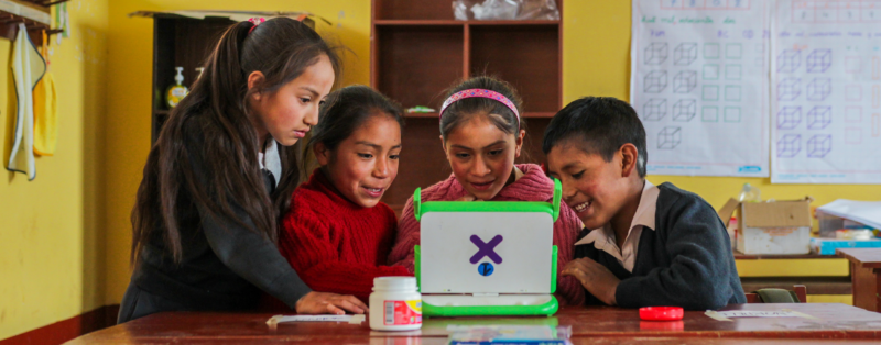 A group of children, energized by the transformative power of a tablet computer, explore and learn in a classroom.