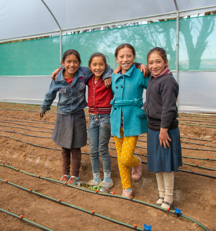 A group of girls embracing brighter futures in a field.
