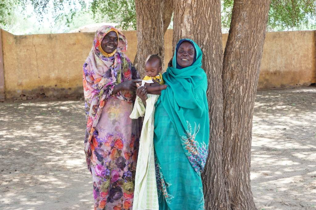Suad Allah (pink) and woman and baby
