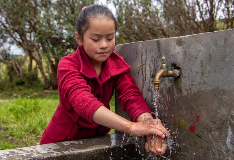 Girl washing her hands in Nepal