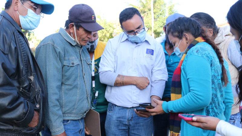 People in masks reading an update on their phones