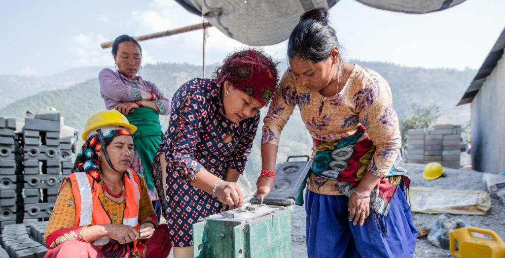 Nepali women working on a construction site, supporting and empowering women.