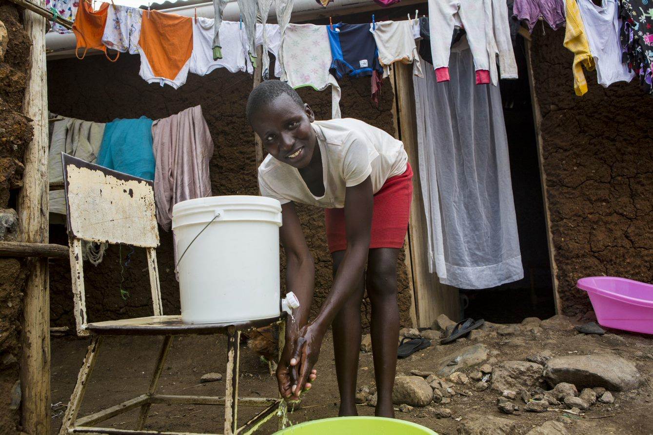 Imelda washes her hands in Kenya