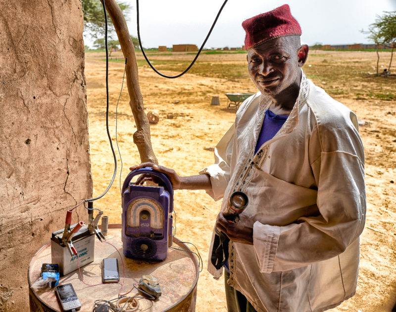 A man demonstrating solar products for refugees in Burkina Faso.