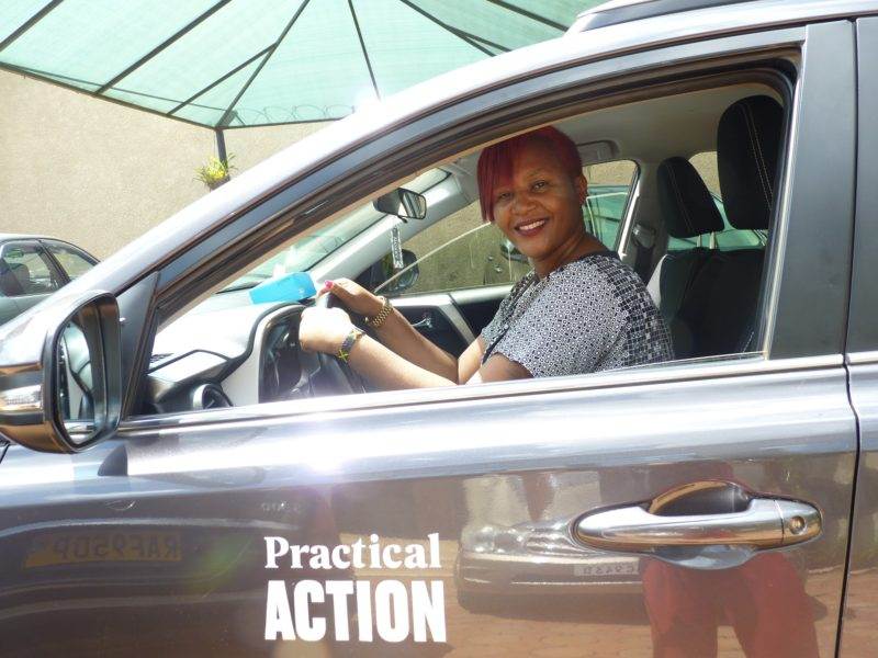 A woman breaking the bias in the driver's seat on International Women's Day.
