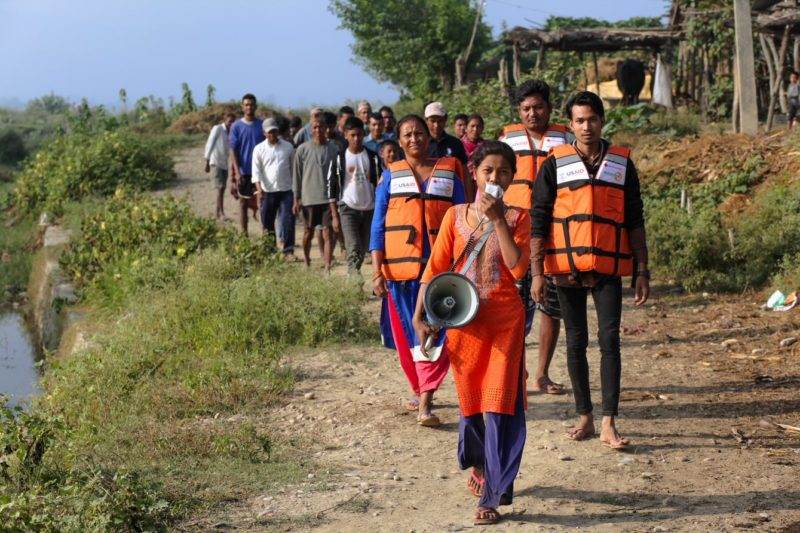 Practical Action's work showcased in new charter for a better world, featuring a group of people wearing life jackets.