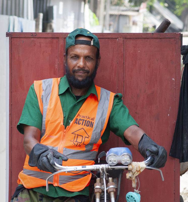 A man transforming litter into a livelihood while riding a bicycle.