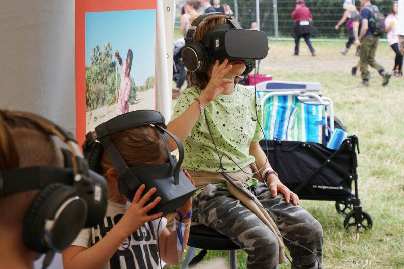 Children at Bluedot 2022 outdoor event wearing VR headsets.