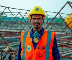 A man in a hard hat symbolizing Stories of Change at a construction site.