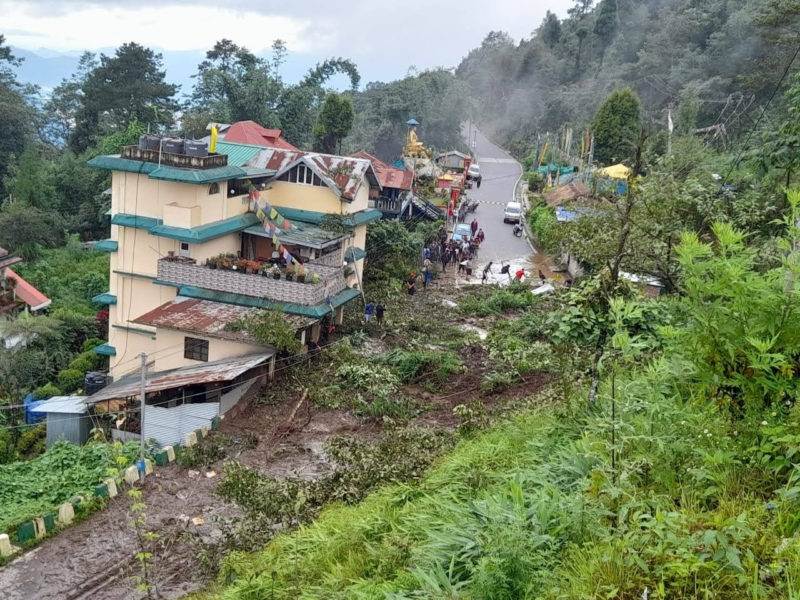 A mountain road built with resilience against landslides, accommodating numerous houses.