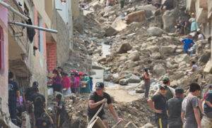 Lima, Chosica in ruins after flash flooding and land slides with workers saving properties