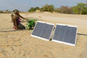 Pictured left - Grace Chiumia. A solar water pump used to pump water from Lake Malawi to the greenhouses