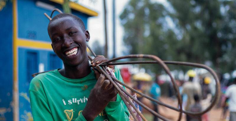 A young man holding a wire, featured in the Annual Report for 2022.