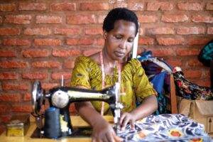 A woman is fostering energising futures for refugee communities through sewing.