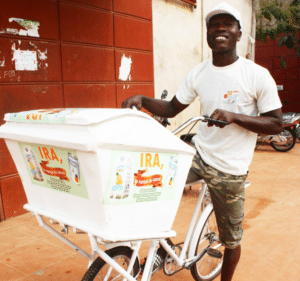 A man on a bicycle promoting clean cooking.