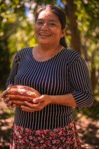 A woman holding a piece of bread in the Amazon forests.