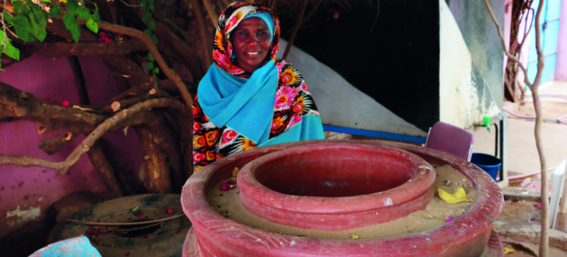 The Food Preservation Problem personified in a woman standing next to a red pot.