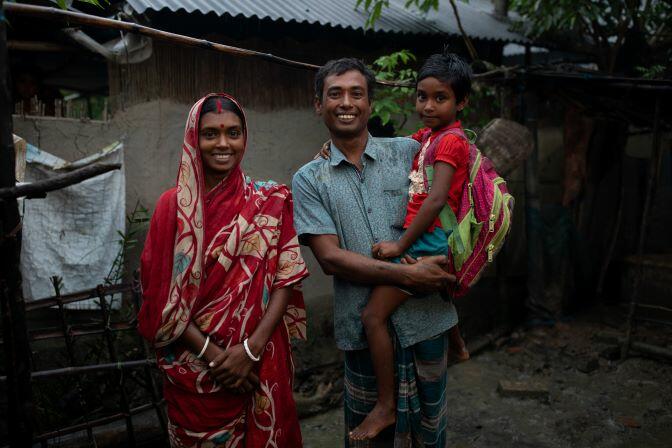 A family with a child in a shack in bangladesh.