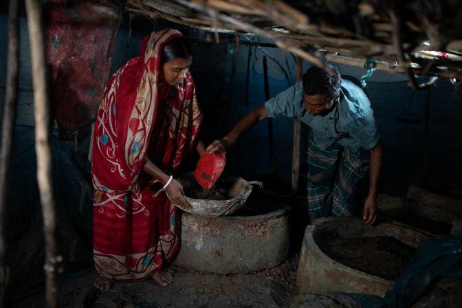 In Bangladesh, worms are bringing hope to a man and a woman living in a hut with pots on the floor.